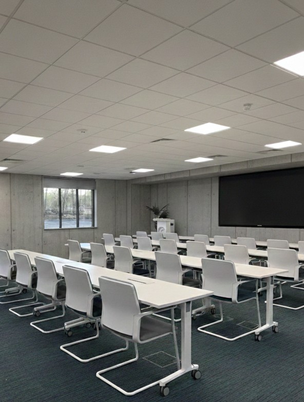 Commercial office fit-out after - completed training room with modern furniture and professional finish